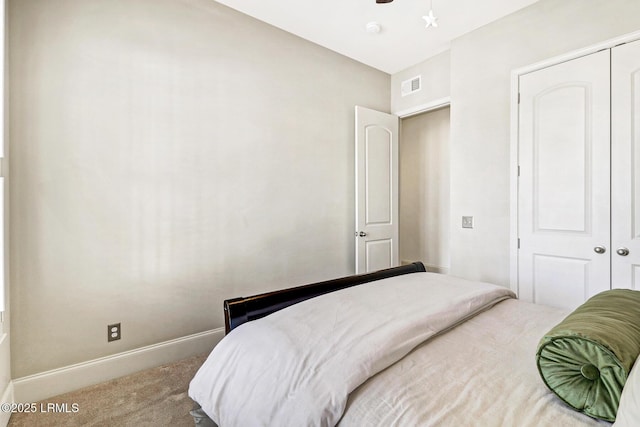 carpeted bedroom featuring a closet