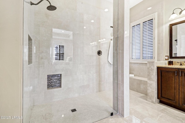 bathroom featuring vanity and a tile shower