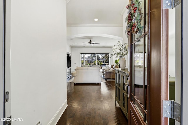 hallway featuring dark wood-type flooring and ornamental molding