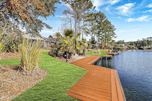 view of dock featuring a water view and a lawn