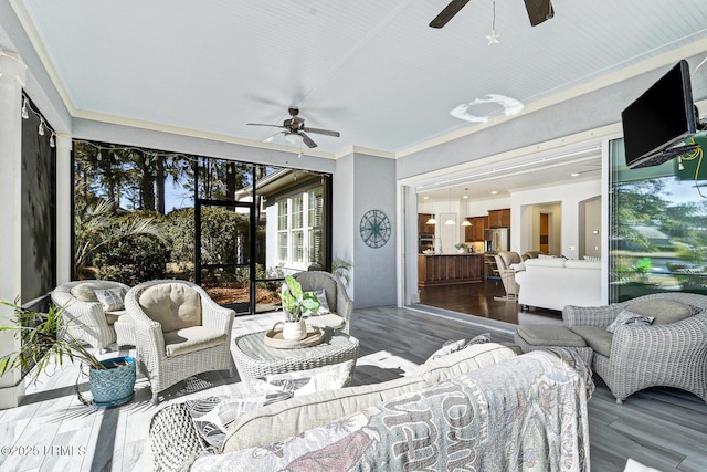 sunroom / solarium with ceiling fan and plenty of natural light