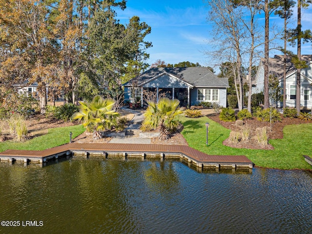 back of property featuring a lawn and a water view