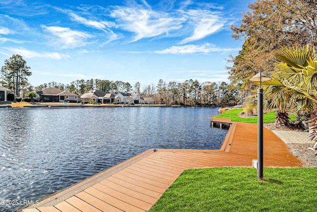 dock area featuring a water view and a lawn