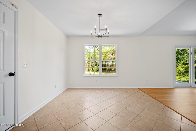 7 Grandiflora Ln, Beaufort, SC 29907 - spare room featuring light tile patterned floors, healthy amount of natural light, a chandelier, and baseboards