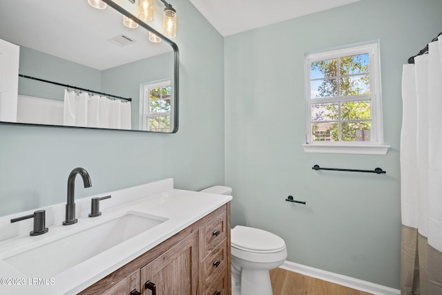 7 Grandiflora Ln, Beaufort, SC 29907 - full bathroom featuring wood finished floors, vanity, baseboards, toilet, and a shower with curtain
