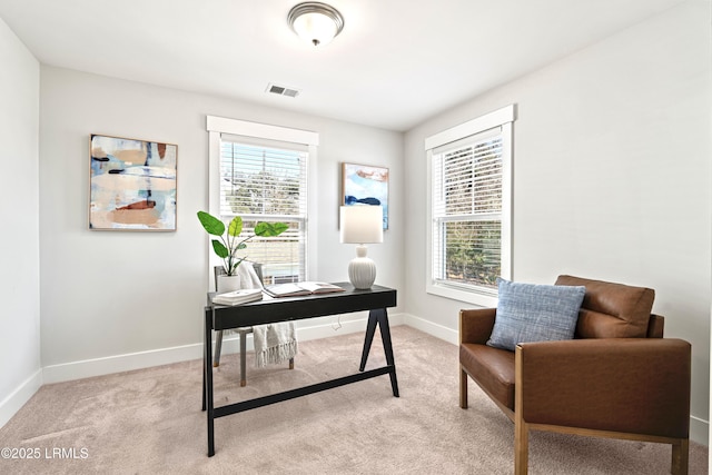 office space with light carpet, visible vents, and baseboards