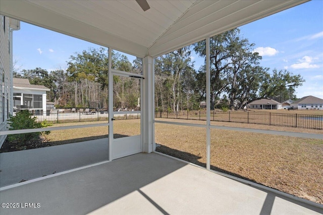 unfurnished sunroom featuring lofted ceiling