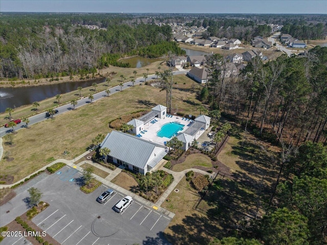 aerial view featuring a water view and a view of trees