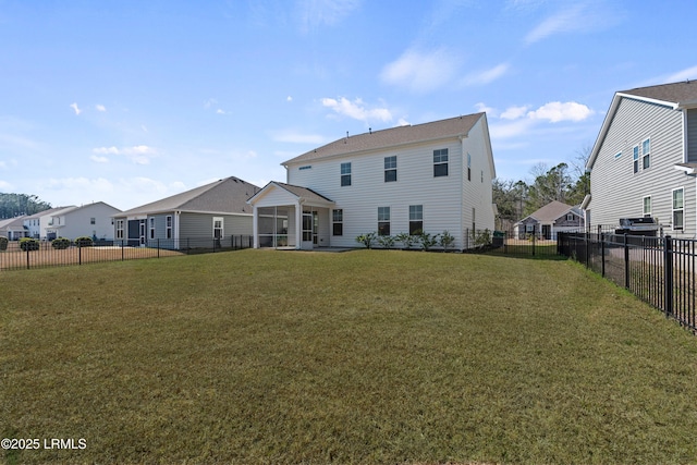 rear view of property featuring a fenced backyard and a yard