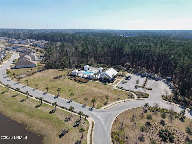 drone / aerial view featuring a wooded view