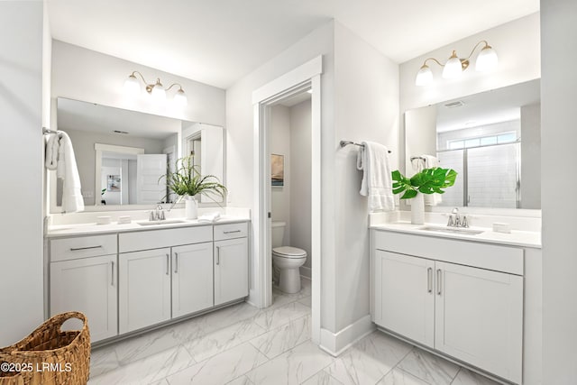 full bath with marble finish floor, two vanities, and a sink