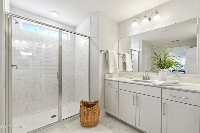 bathroom with marble finish floor, a shower stall, and visible vents