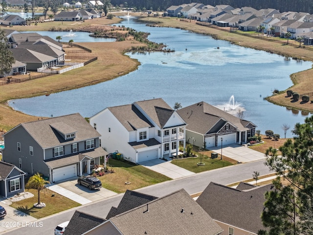 birds eye view of property with a water view and a residential view