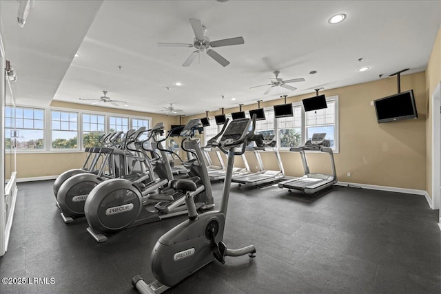 gym featuring recessed lighting, a wealth of natural light, and baseboards