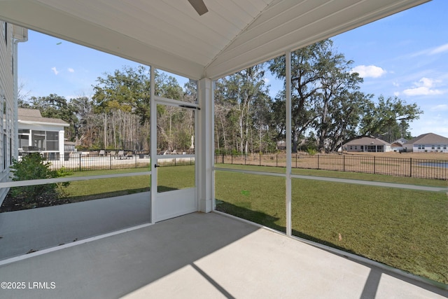 unfurnished sunroom featuring lofted ceiling