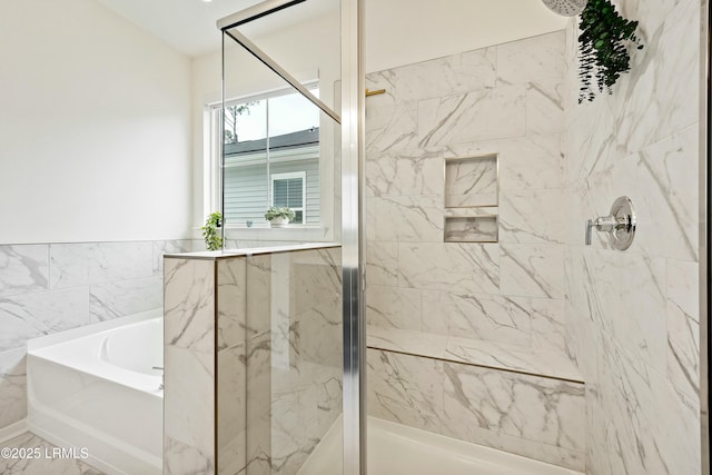 bathroom featuring shower with separate bathtub