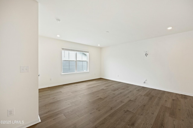 spare room with dark hardwood / wood-style floors