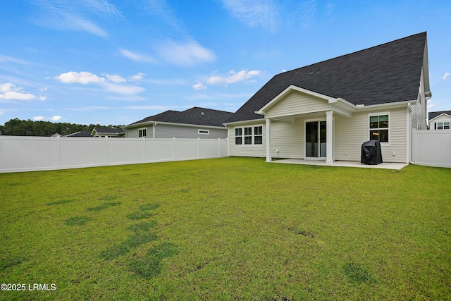 rear view of house with a patio and a yard