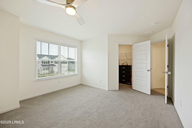 unfurnished bedroom featuring light carpet and ceiling fan