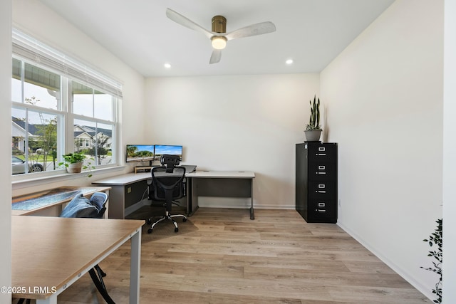 home office featuring light hardwood / wood-style floors and ceiling fan