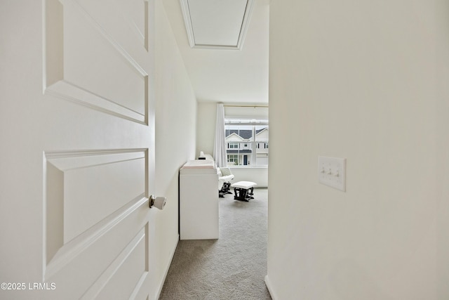 hallway featuring light colored carpet