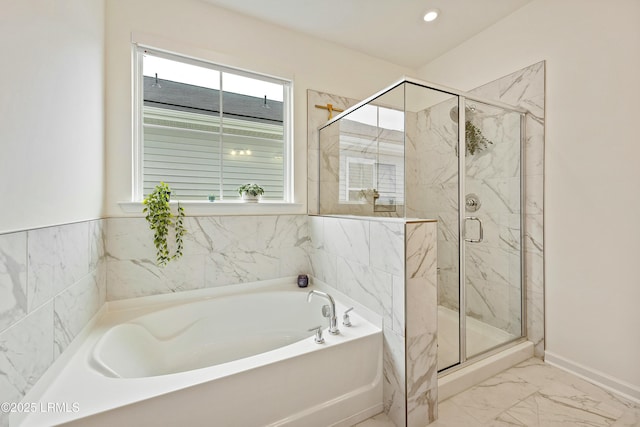 bathroom featuring independent shower and bath