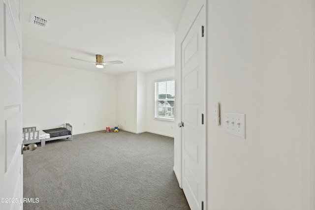 empty room with carpet flooring and ceiling fan