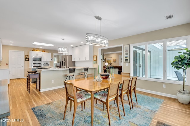 9 Spartina Cres, Bluffton, SC 29910 - dining area with light wood-style floors, a chandelier, recessed lighting, and baseboards