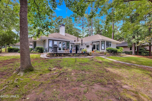 9 Spartina Cres, Bluffton, SC 29910 - view of front of home featuring french doors, a chimney, a front yard, and a patio area