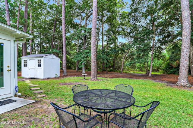 view of yard featuring a storage shed and an outdoor structure