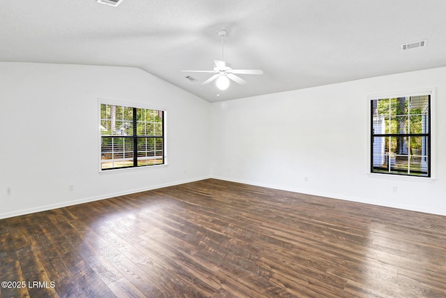 unfurnished room with dark wood-type flooring, a ceiling fan, visible vents, and plenty of natural light