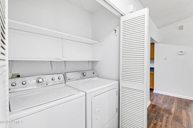 laundry area with laundry area, dark wood-style flooring, and washing machine and dryer