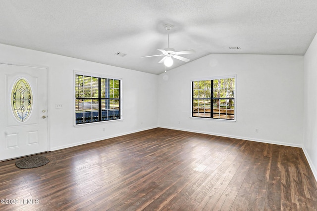 foyer entrance featuring a healthy amount of sunlight, lofted ceiling, dark wood-style flooring, and ceiling fan