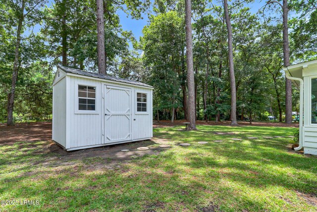 view of yard with an outbuilding and a shed