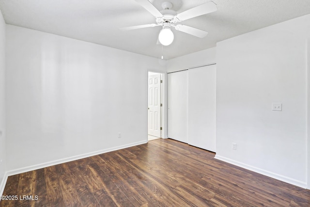 spare room featuring wood finished floors, baseboards, and a ceiling fan