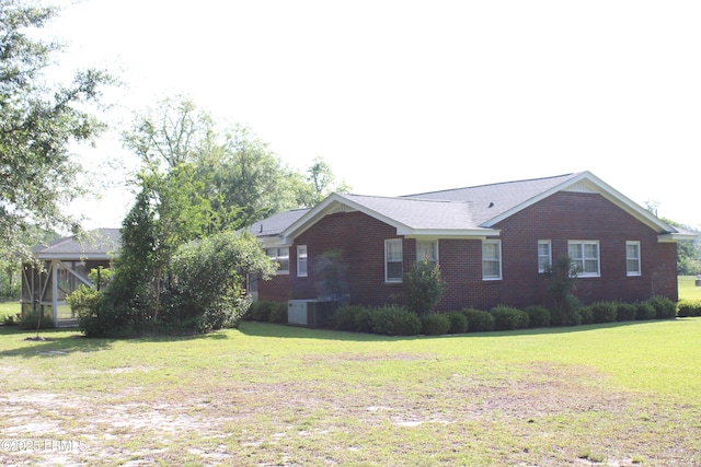 1933 Bamberg Hwy, Hampton, SC 29924 - view of side of property with brick siding, a gazebo, a yard, and central air condition unit