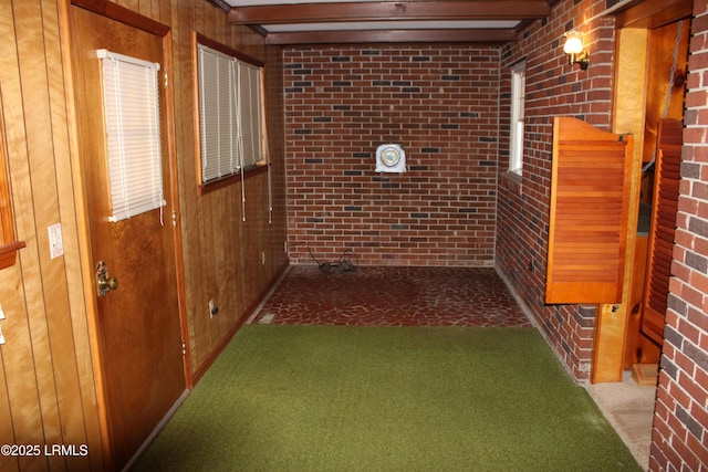 1933 Bamberg Hwy, Hampton, SC 29924 - hallway featuring carpet flooring, wood walls, brick wall, and beam ceiling