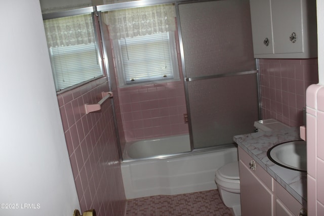 1933 Bamberg Hwy, Hampton, SC 29924 - bathroom featuring tile walls, toilet, vanity, and combined bath / shower with glass door