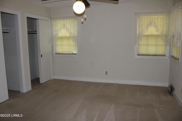 1933 Bamberg Hwy, Hampton, SC 29924 - unfurnished bedroom featuring carpet flooring, baseboards, multiple closets, and a ceiling fan