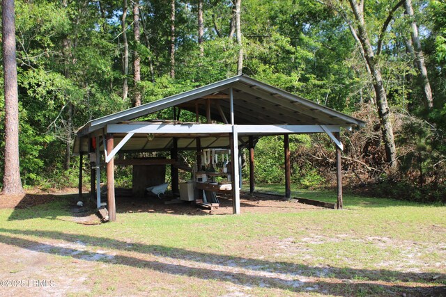 1933 Bamberg Hwy, Hampton, SC 29924 - view of parking featuring a detached carport and a forest view