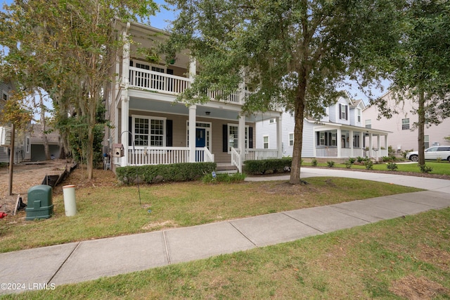 view of front facade featuring a front lawn, a balcony, and a porch