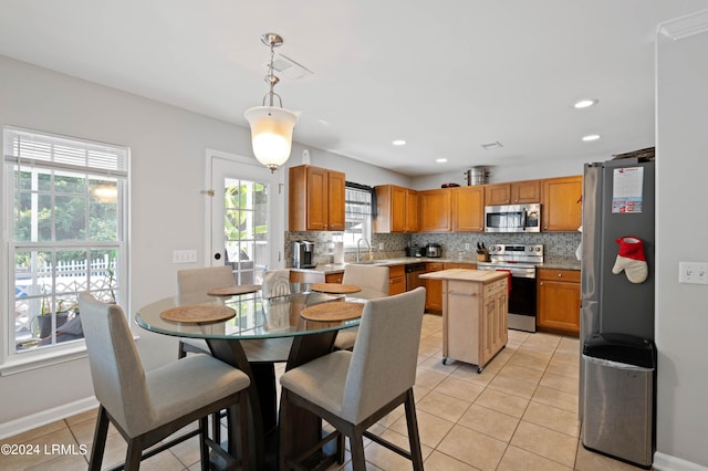 dining room with sink and light tile patterned floors