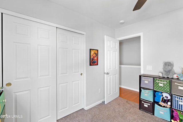 bedroom with light colored carpet, a closet, and ceiling fan