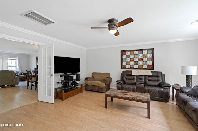 living room featuring crown molding, ceiling fan, light hardwood / wood-style floors, and french doors