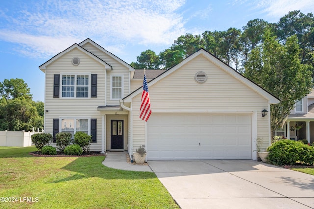 view of front property featuring a garage and a front yard