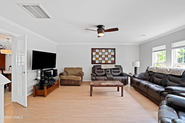 living room with ornamental molding, ceiling fan, and light wood-type flooring