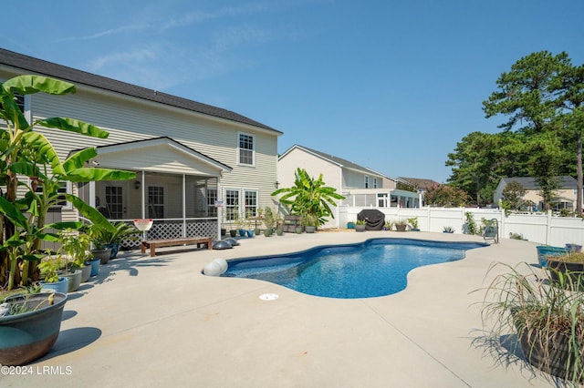 view of pool with a patio and a sunroom