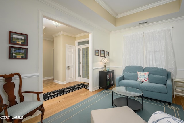 living room with hardwood / wood-style flooring and crown molding