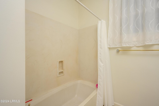 bathroom featuring shower / bath combination with curtain