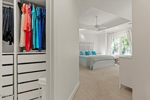 bedroom with carpet floors, ornamental molding, a closet, and ceiling fan